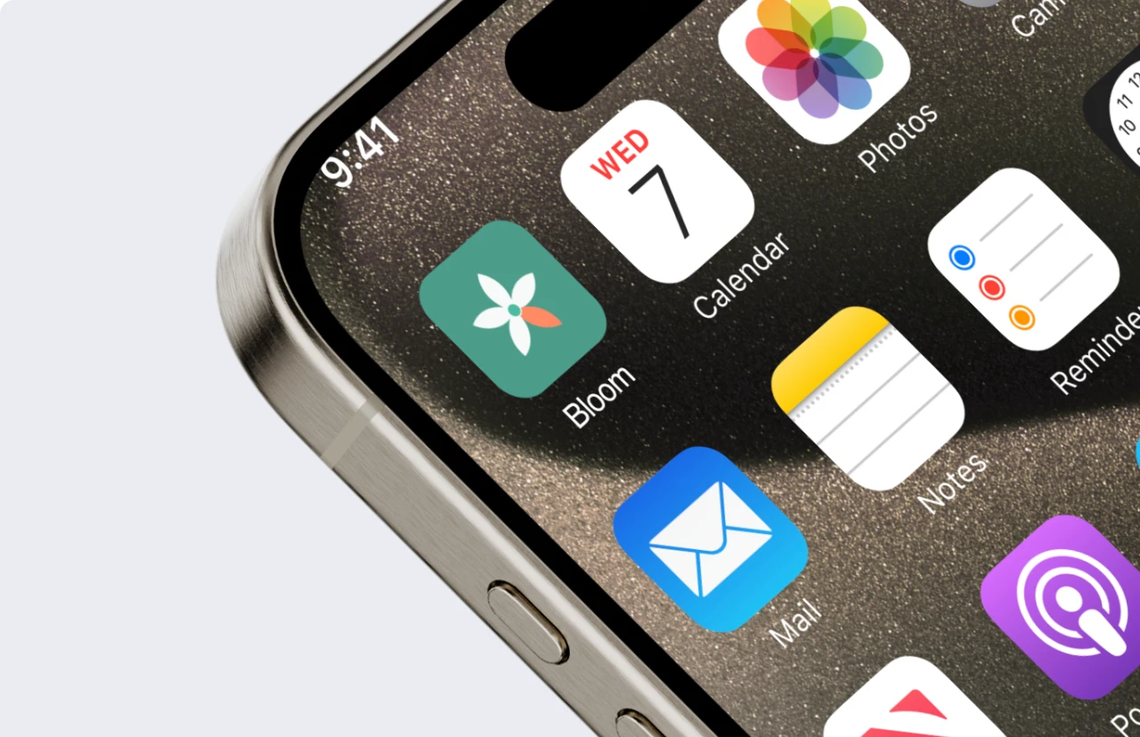 iPhone home screen closeup showing the Bloom app icon among daily apps